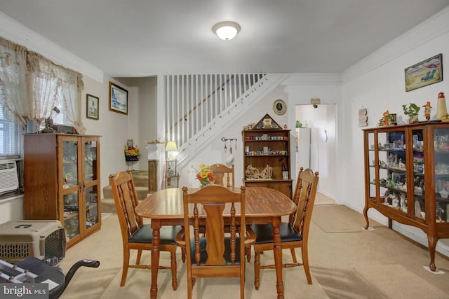 carpeted dining area featuring crown molding