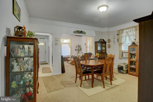 dining room featuring light carpet, crown molding, and cooling unit