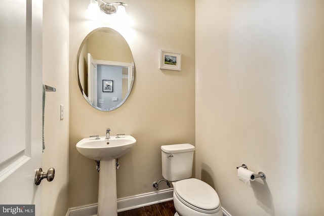 bathroom with wood-type flooring and toilet