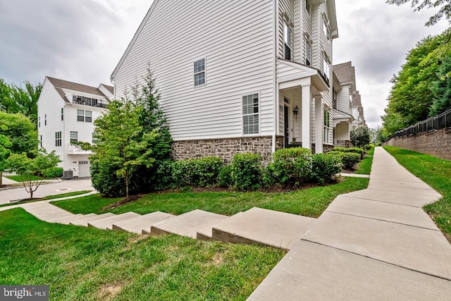 view of side of home with a yard