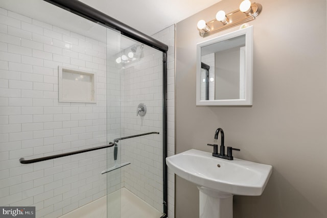 bathroom with walk in shower and sink