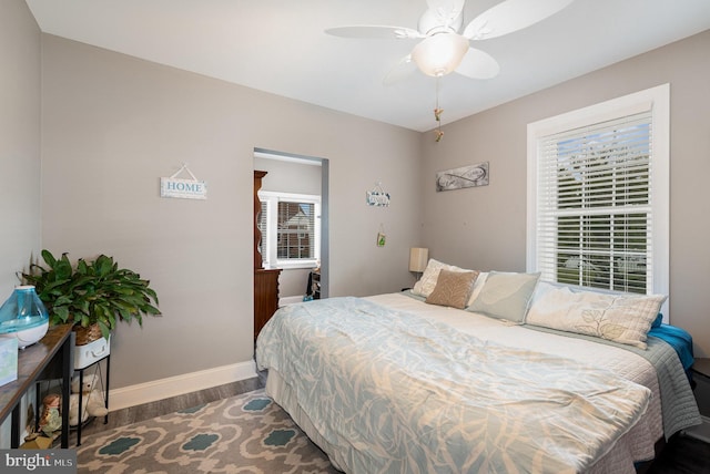 bedroom with dark hardwood / wood-style floors and ceiling fan