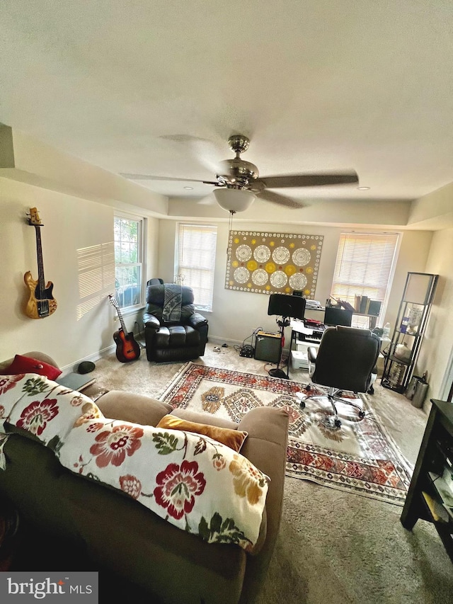 carpeted living room featuring ceiling fan