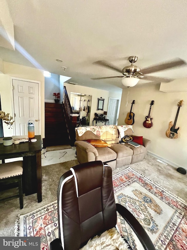 carpeted living room with ceiling fan