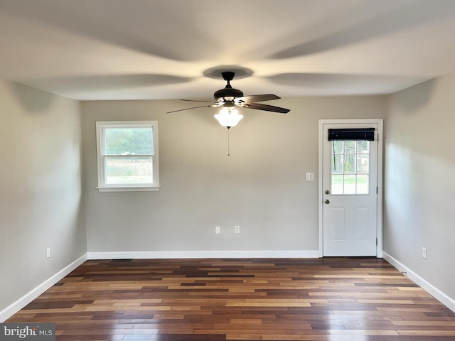 interior space featuring ceiling fan, dark hardwood / wood-style floors, and plenty of natural light