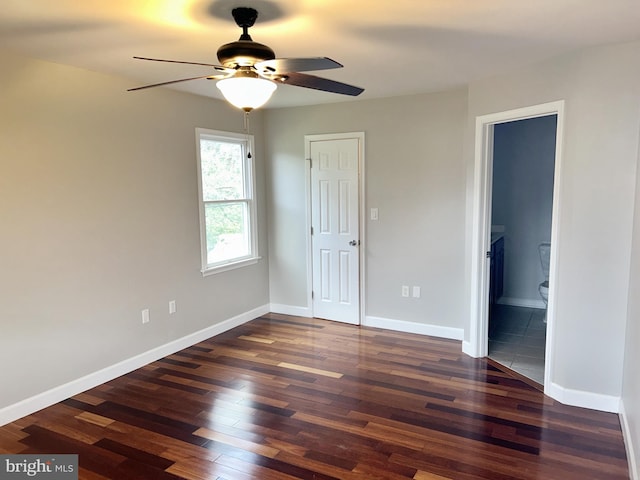 unfurnished bedroom with connected bathroom, ceiling fan, and dark hardwood / wood-style flooring