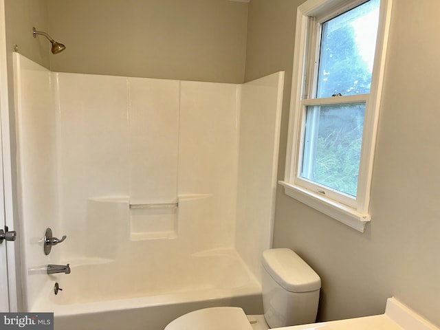 bathroom with toilet and washtub / shower combination