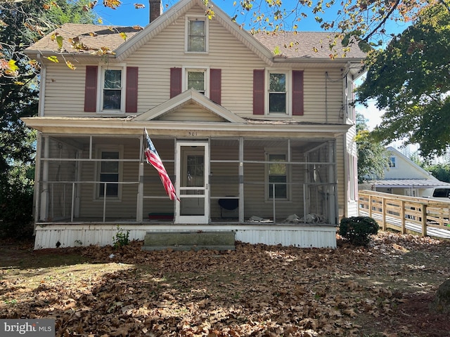 view of front of house with a sunroom and a porch