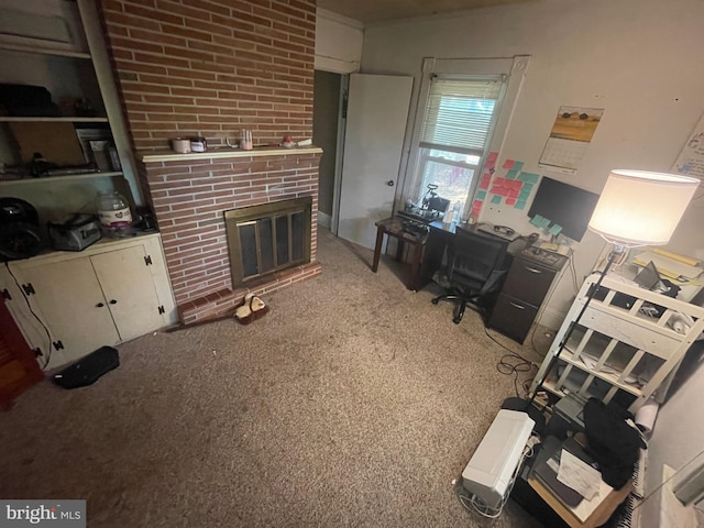 carpeted office featuring a brick fireplace