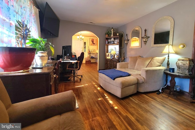 living room featuring hardwood / wood-style flooring and a chandelier