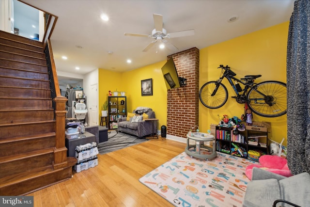 living room with wood-type flooring and ceiling fan