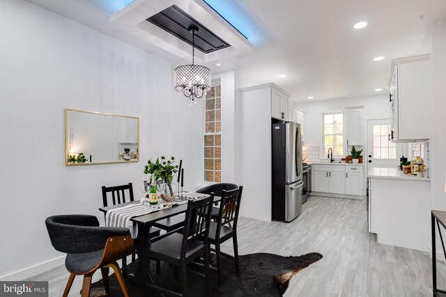 dining area featuring sink and light wood-type flooring