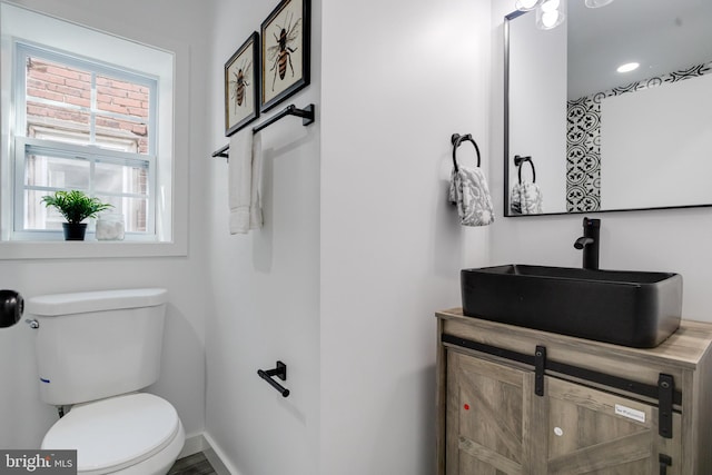 bathroom featuring vanity and toilet