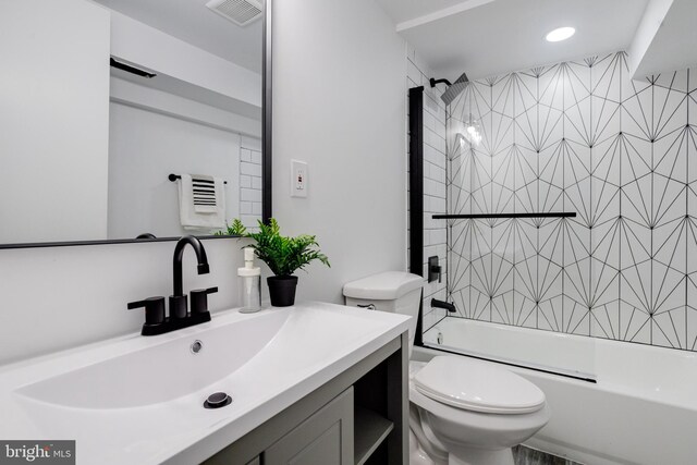 full bathroom featuring vanity, toilet, and tiled shower / bath