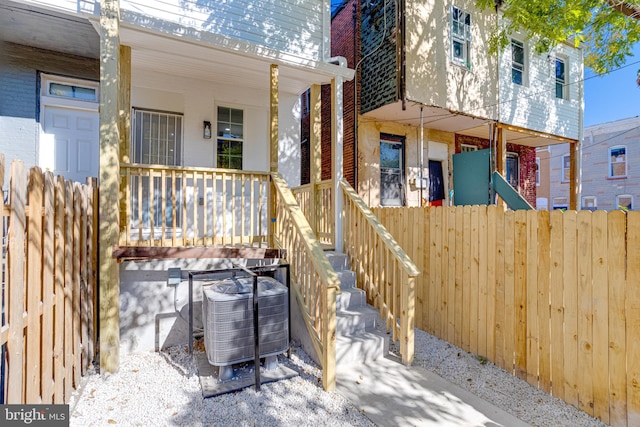 exterior space with central air condition unit and a porch