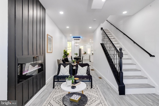 interior space featuring light hardwood / wood-style flooring and a notable chandelier