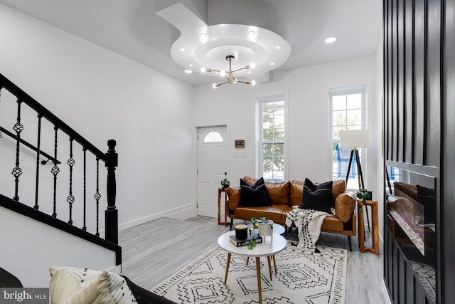 living room with light hardwood / wood-style floors and a chandelier