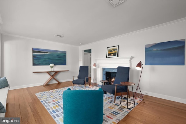 living room featuring crown molding and hardwood / wood-style flooring