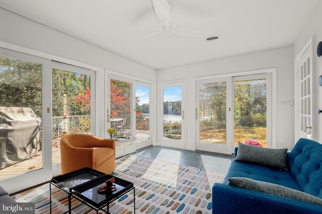 sunroom featuring ceiling fan and a healthy amount of sunlight