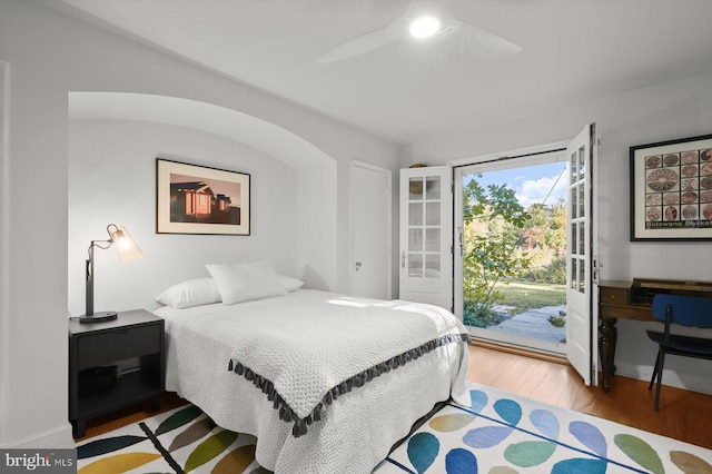 bedroom featuring hardwood / wood-style floors, access to outside, and ceiling fan