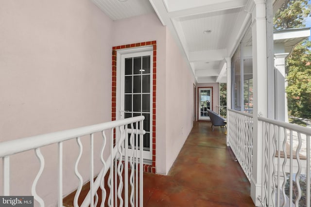 hall featuring coffered ceiling and beam ceiling