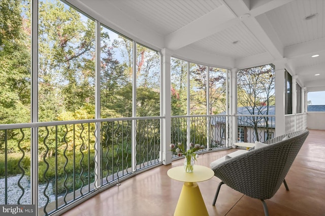 sunroom featuring beam ceiling