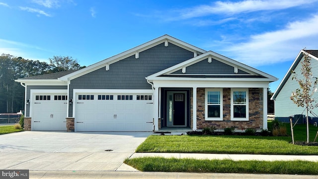 craftsman-style home featuring a front yard and a garage