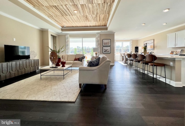 living room with wood ceiling, ornamental molding, a tray ceiling, and dark wood-type flooring