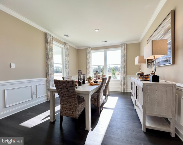 dining space featuring ornamental molding and dark hardwood / wood-style floors