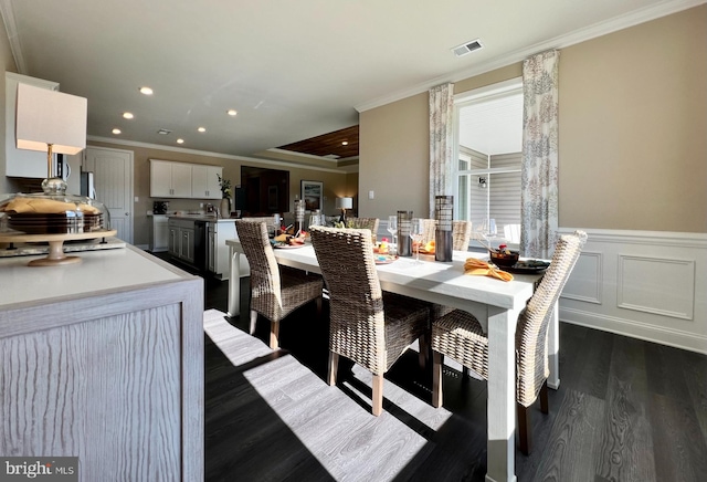 dining area featuring ornamental molding and dark hardwood / wood-style floors