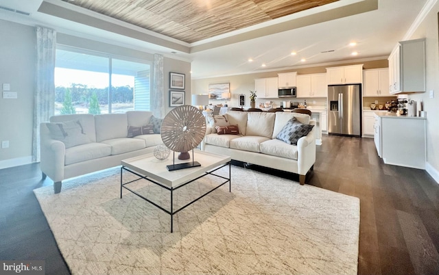 living room with light hardwood / wood-style flooring, ornamental molding, and a tray ceiling