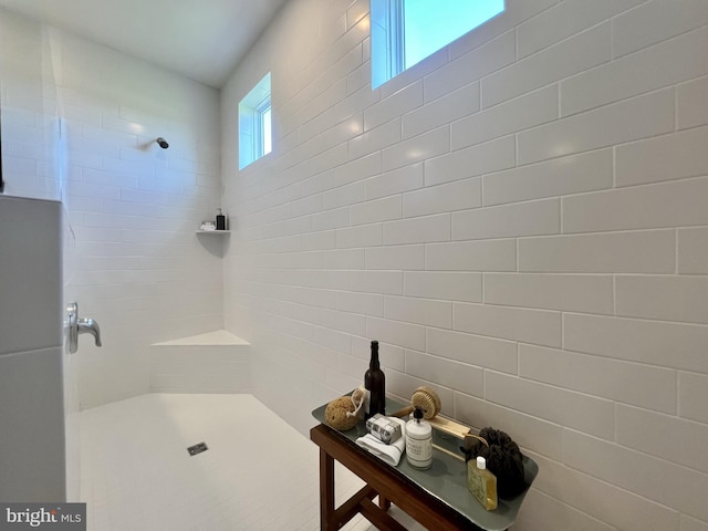 bathroom with a tile shower