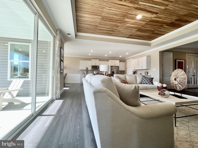 living room featuring ornamental molding, wood ceiling, hardwood / wood-style floors, and a tray ceiling