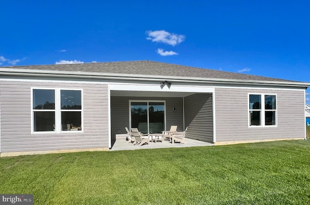 back of house with a yard and a patio area