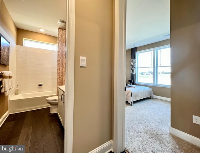 full bathroom with vanity, hardwood / wood-style flooring, toilet, and shower / bathtub combination