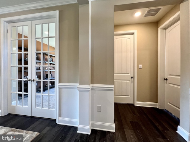 doorway with french doors, ornamental molding, and dark hardwood / wood-style flooring