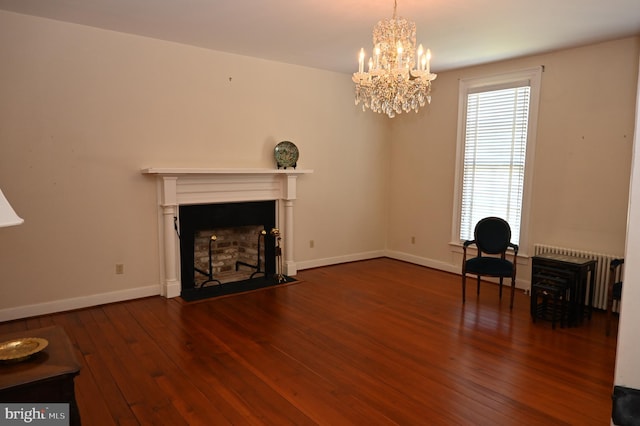 unfurnished living room featuring dark wood-type flooring, a chandelier, and radiator