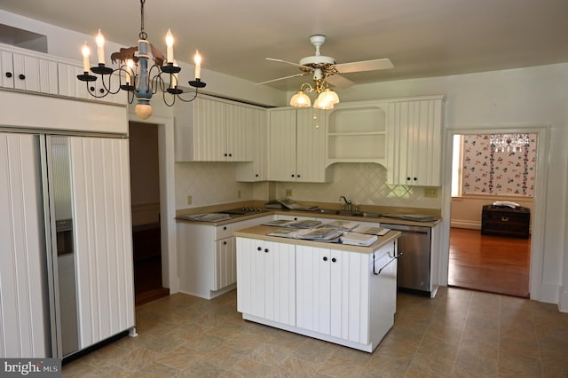 kitchen featuring tasteful backsplash, a kitchen island, stainless steel dishwasher, pendant lighting, and paneled built in refrigerator