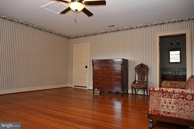 unfurnished room with sink, wood-type flooring, and ceiling fan