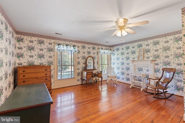 unfurnished room with ceiling fan, crown molding, and wood-type flooring