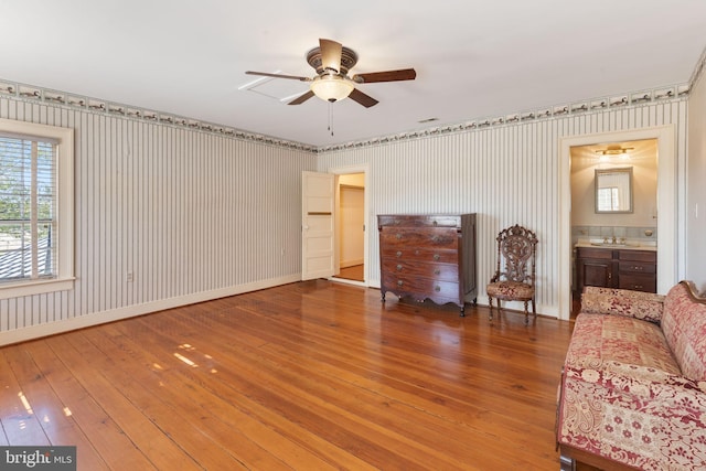 unfurnished living room with ceiling fan and hardwood / wood-style flooring