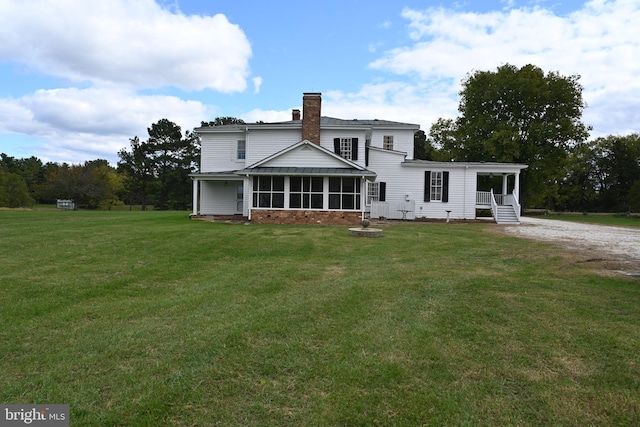 back of property featuring a sunroom, a lawn, and cooling unit