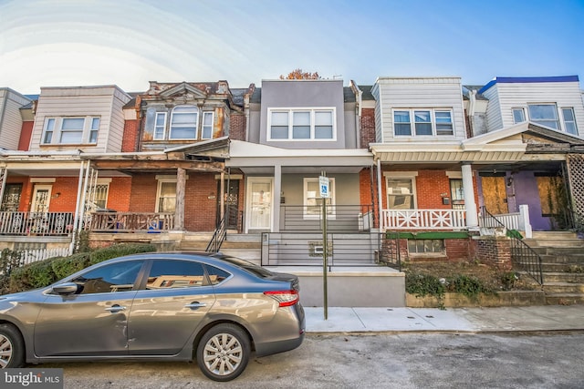 townhome / multi-family property featuring a porch