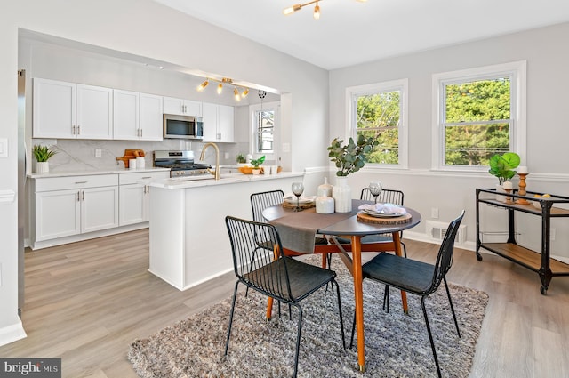 dining space featuring light wood-type flooring