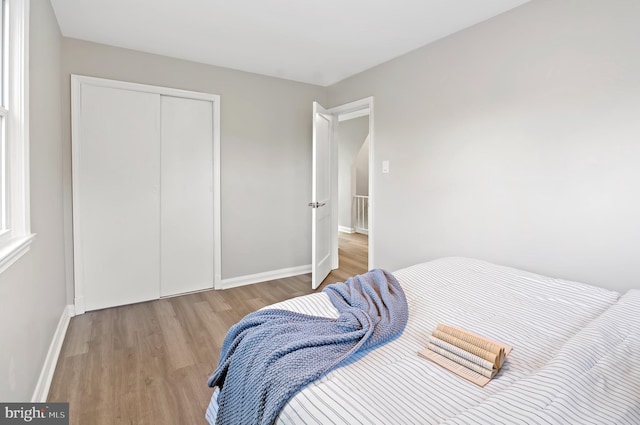 bedroom with a closet and light wood-type flooring