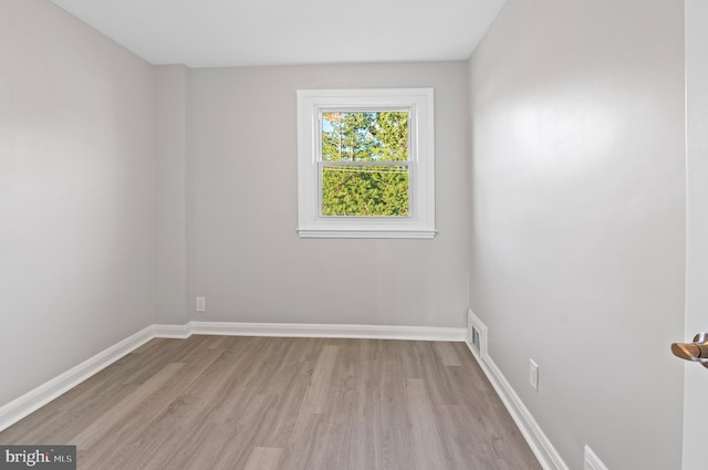 empty room with light hardwood / wood-style flooring