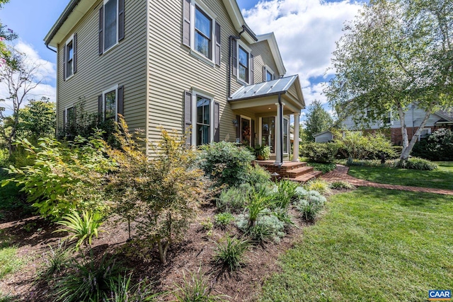 view of property exterior featuring a lawn