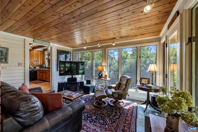 sunroom / solarium featuring rail lighting, wooden ceiling, and plenty of natural light