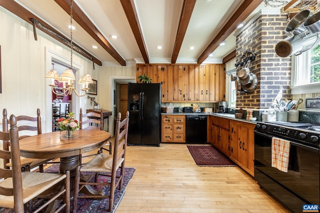 kitchen with beamed ceiling, black appliances, pendant lighting, and light wood-type flooring