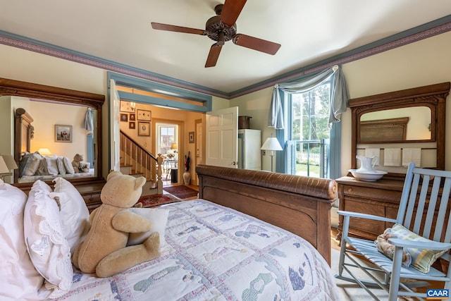 bedroom with ornamental molding and ceiling fan